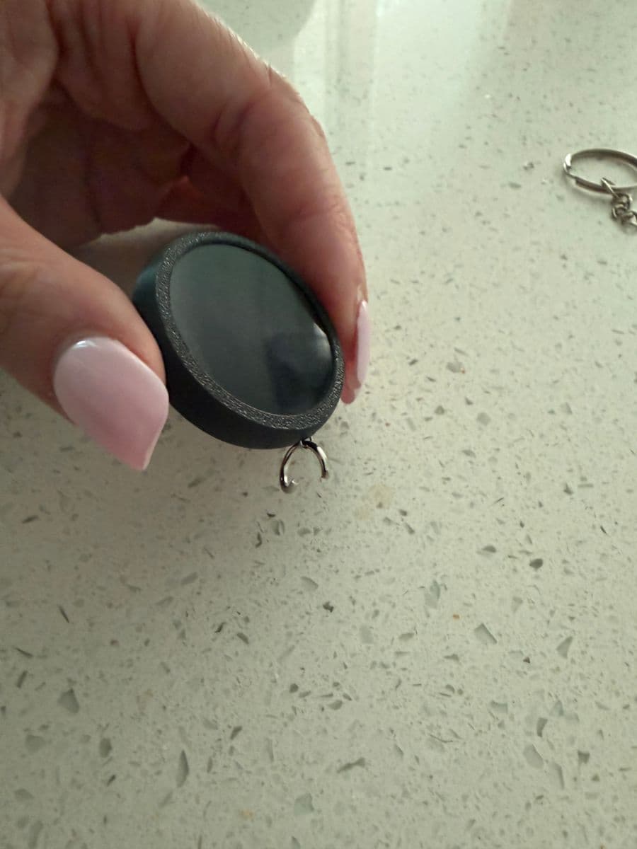 Larger joiner ring hooked through the small ring, left open